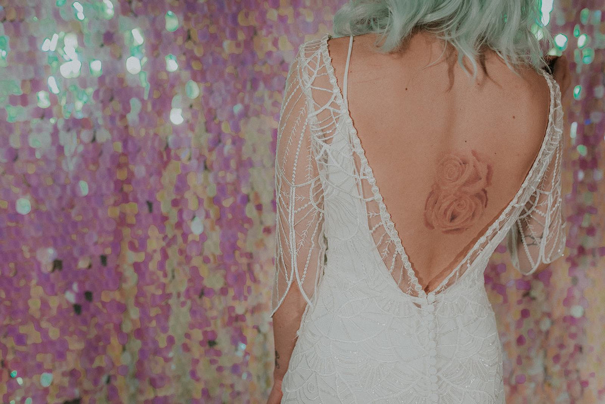 Back shot of a Bohemian inspired wedding dress with sequined lace - Lookbook